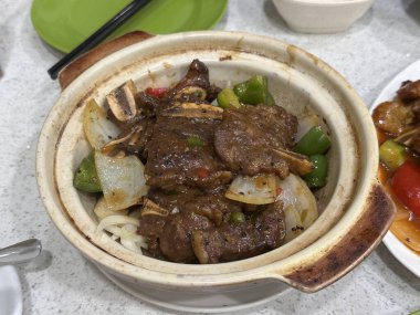 Çin usulü, seramik güveçte karabiberli kızarmış sığır kaburgası.