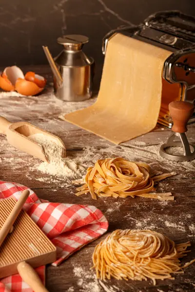 stock image Fresh pasta homemade preparation. Pasta machine and ingredients on a kitchen table. Close up