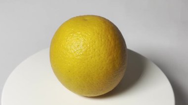 Bu video, bir turntable üzerinde yavaşça dönen bir portakalın yakın çekimi. Bir portakalın parlak portakal kabuğuyla başlayan tüm detaylarını görebilirsiniz..