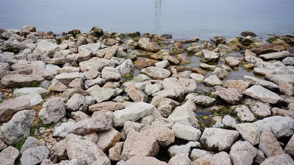 stock image stones and rocks on the shore of lake Garda breakwater. High quality photo