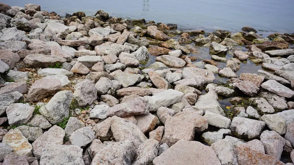 stock image stones and rocks on the shore of lake Garda breakwater. High quality photo