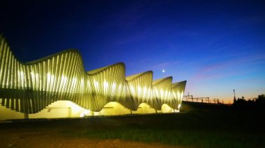 panorama by night Reggio Emilia high speed railway station. High quality photo clipart