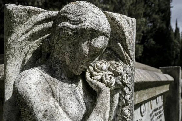 old woman crying statue in abandoned cemetery. High quality photo