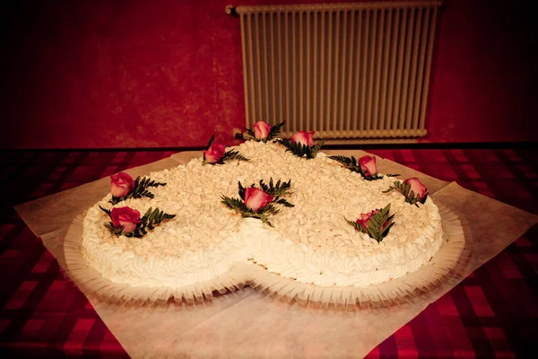 stock image heart shaped wedding cake with cream and flowers. High quality photo