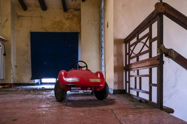 toy pedal car in abandoned house. High quality photo