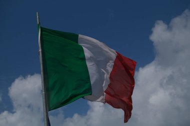 Italian tricolor flag waving in the wind in sunny day. High quality photo