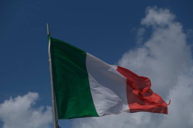 Italian tricolor flag waving in the wind in sunny day. High quality photo