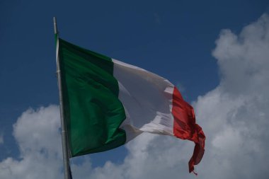 Italian tricolor flag waving in the wind in sunny day. High quality photo