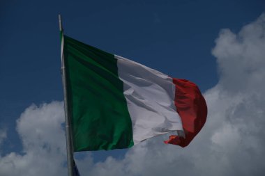 Italian tricolor flag waving in the wind in sunny day. High quality photo