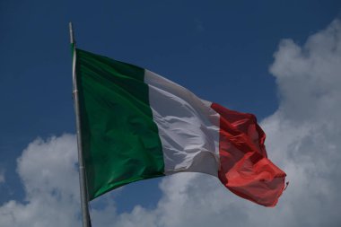 Italian tricolor flag waving in the wind in sunny day. High quality photo