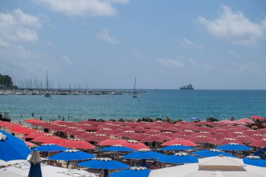 Lerici beach in Liguria with colorful umbrellas in sunny day. High quality photo