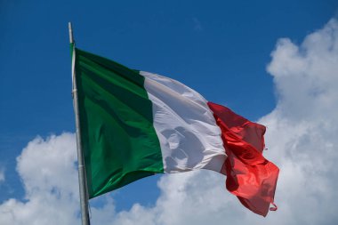 Italian tricolor flag waving in the wind in sunny day. High quality photo