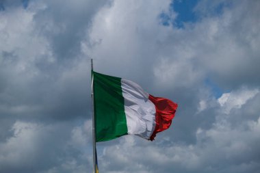 Italian tricolor flag waving in the wind in sunny day. High quality photo