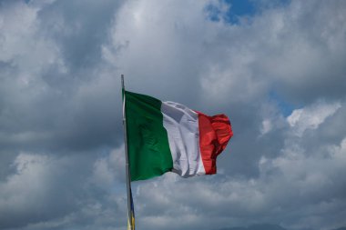 Italian tricolor flag waving in the wind in sunny day. High quality photo