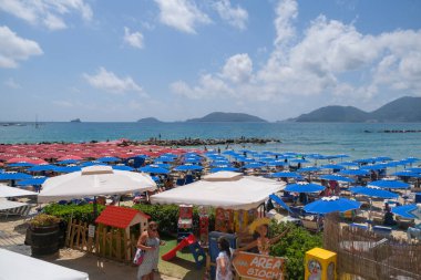 Lerici beach in Liguria with colorful umbrellas in sunny day. High quality photo
