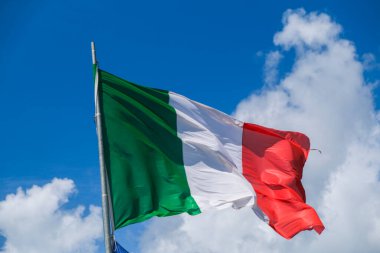 Italian tricolor flag waving in the wind in sunny day. High quality photo
