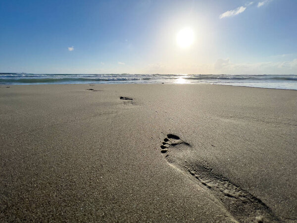 footprints in the sand of the seashore. High quality photo
