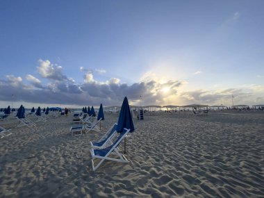 umbrellas and deck chairs closed on the beach. High quality photo