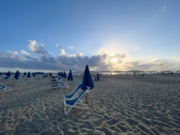 stock image umbrellas and deck chairs closed on the beach. High quality photo