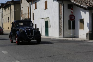 Bibbiano-Reggio Emilia Italy - 07 15 2015 : Free rally of vintage cars in the town square Fiat Topolino black. High quality photo