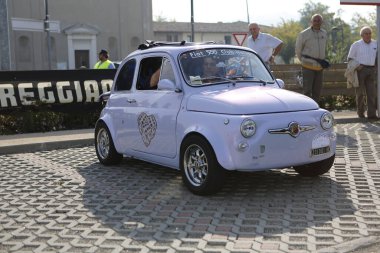 Bibbiano-Reggio Emilia Italy - 07 15 2015 : Free rally of vintage cars in the town square purple Fiat 500. High quality photo