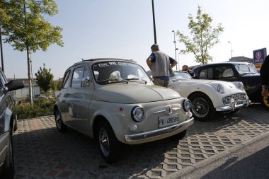 Bibbiano-Reggio Emilia Italy - 07 15 2015 : Free rally of vintage cars in the town square white Fiat 500. High quality photo