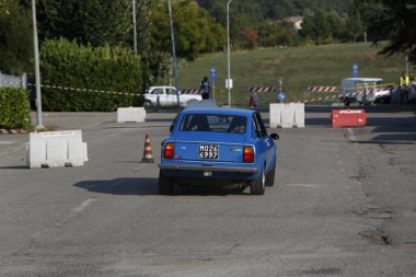 Bibbiano-Reggio Emilia Italy - 07 15 2015 : Free rally of vintage cars in the town square Fiat 124 Rally Blue. High quality photo