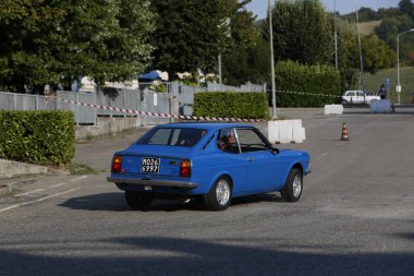 Bibbiano-Reggio Emilia Italy - 07 15 2015 : Free rally of vintage cars in the town square Fiat 124 Rally Blue. High quality photo