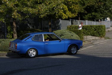 Bibbiano-Reggio Emilia Italy - 07 15 2015 : Free rally of vintage cars in the town square Fiat 124 Rally Blue. High quality photo