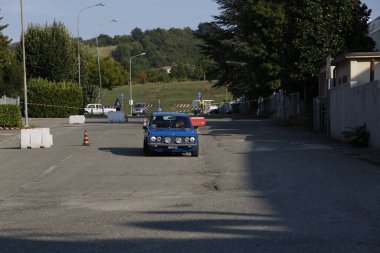 Bibbiano-Reggio Emilia Italy - 07 15 2015 : Free rally of vintage cars in the town square Fiat 124 Rally Blue. High quality photo