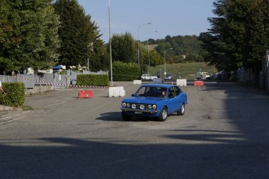 Bibbiano-Reggio Emilia Italy - 07 15 2015 : Free rally of vintage cars in the town square Fiat 124 Rally Blue. High quality photo