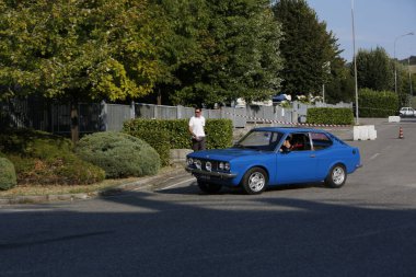 Bibbiano-Reggio Emilia Italy - 07 15 2015 : Free rally of vintage cars in the town square Fiat 124 Rally Blue. High quality photo