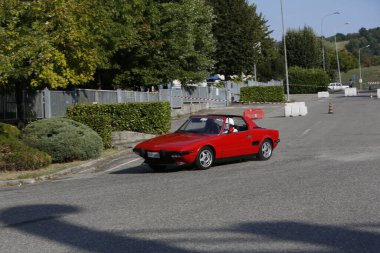 Bibbiano-Reggio Emilia Italy - 07 15 2015 : Free rally of vintage cars in the town square red Fiat X1 9 . High quality photo