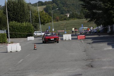 Bibbiano-Reggio Emilia Italy - 07 15 2015 : Free rally of vintage cars in the town square red Fiat X1 9 . High quality photo