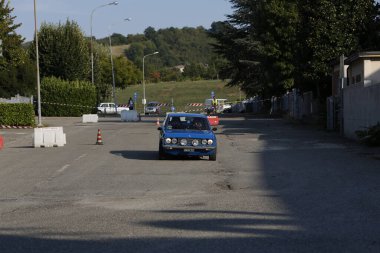 Bibbiano-Reggio Emilia Italy - 07 15 2015 : Free rally of vintage cars in the town square Fiat 124 Rally Blue. High quality photo
