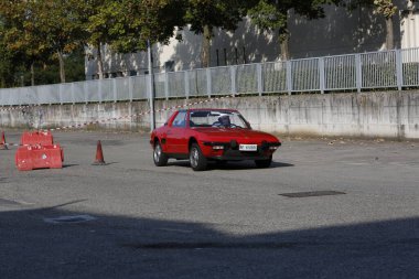 Bibbiano-Reggio Emilia Italy - 07 15 2015 : Free rally of vintage cars in the town square red Fiat X1 9 . High quality photo