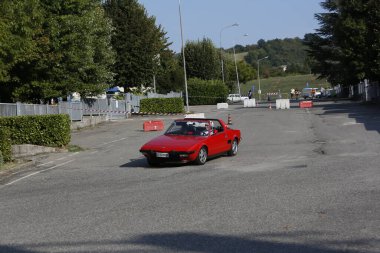 Bibbiano-Reggio Emilia Italy - 07 15 2015 : Free rally of vintage cars in the town square red Fiat X1 9 . High quality photo