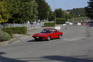 Bibbiano-Reggio Emilia Italy - 07 15 2015 : Free rally of vintage cars in the town square red Fiat X1 9 . High quality photo