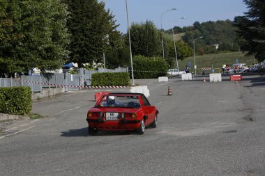 Bibbiano-Reggio Emilia Italy - 07 15 2015 : Free rally of vintage cars in the town square red Fiat X1 9 . High quality photo