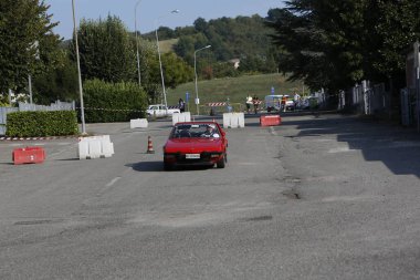 Bibbiano-Reggio Emilia Italy - 07 15 2015 : Free rally of vintage cars in the town square red Fiat X1 9 . High quality photo