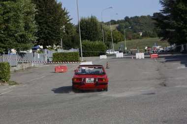 Bibbiano-Reggio Emilia Italy - 07 15 2015 : Free rally of vintage cars in the town square red Fiat X1 9 . High quality photo