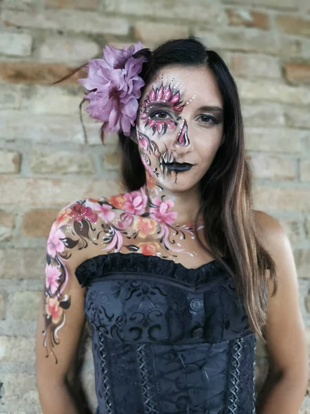 beautiful italian brunette girl with face painted in floral style. High quality photo
