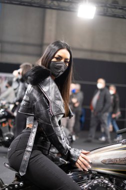 Verona, Italy - 2018 01 12 : MBE Verona Bike Expo Bike and Custom car exibituon - Black Hair Model girl. High quality photo