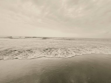 waves on the beach in Italy with dramatic sky. High quality photo