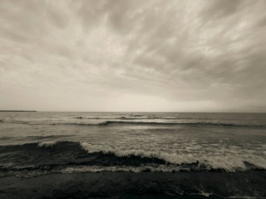 waves on the beach in Italy with dramatic sky. High quality photo