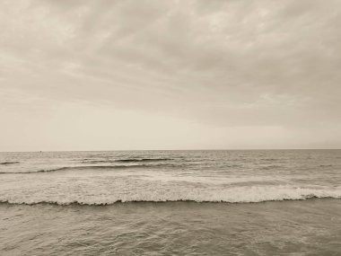 waves on the beach in Italy with dramatic sky. High quality photo