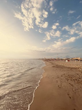 waves on the beach in Italy with dramatic sky. High quality photo