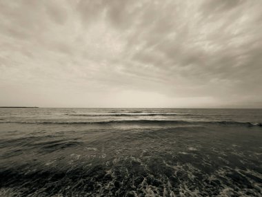 waves on the beach in Italy with dramatic sky. High quality photo