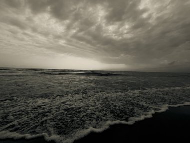 waves on the beach in Italy with dramatic sky. High quality photo