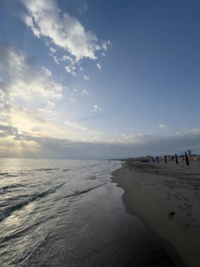 waves on the beach in Italy with dramatic sky. High quality photo